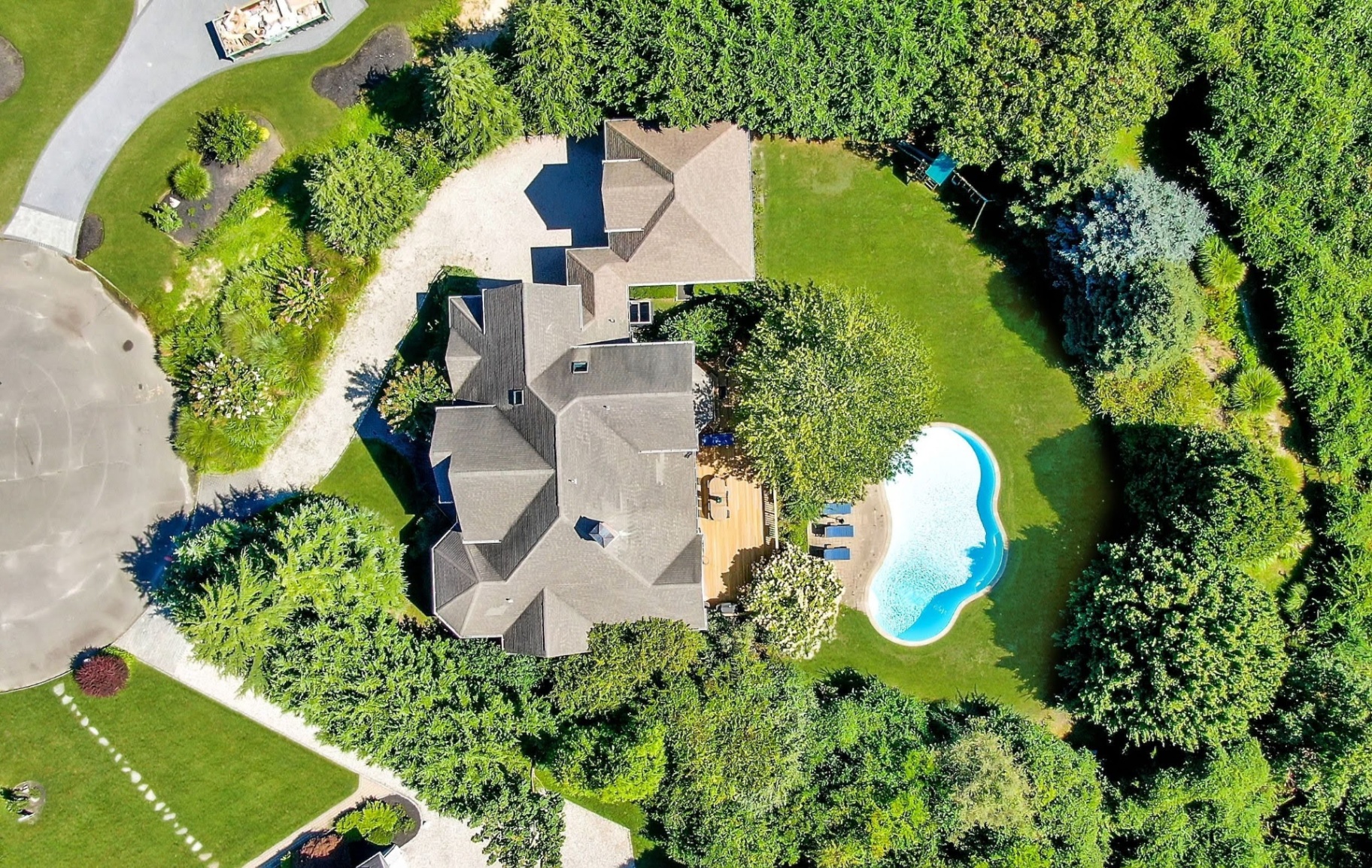 Aerial view of the property, pool, and grounds