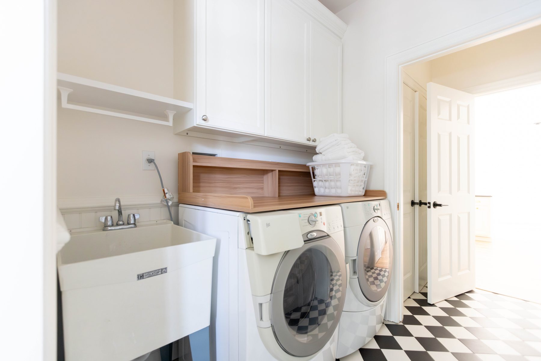 Laundry area — laundry room with checkerboard tile floor