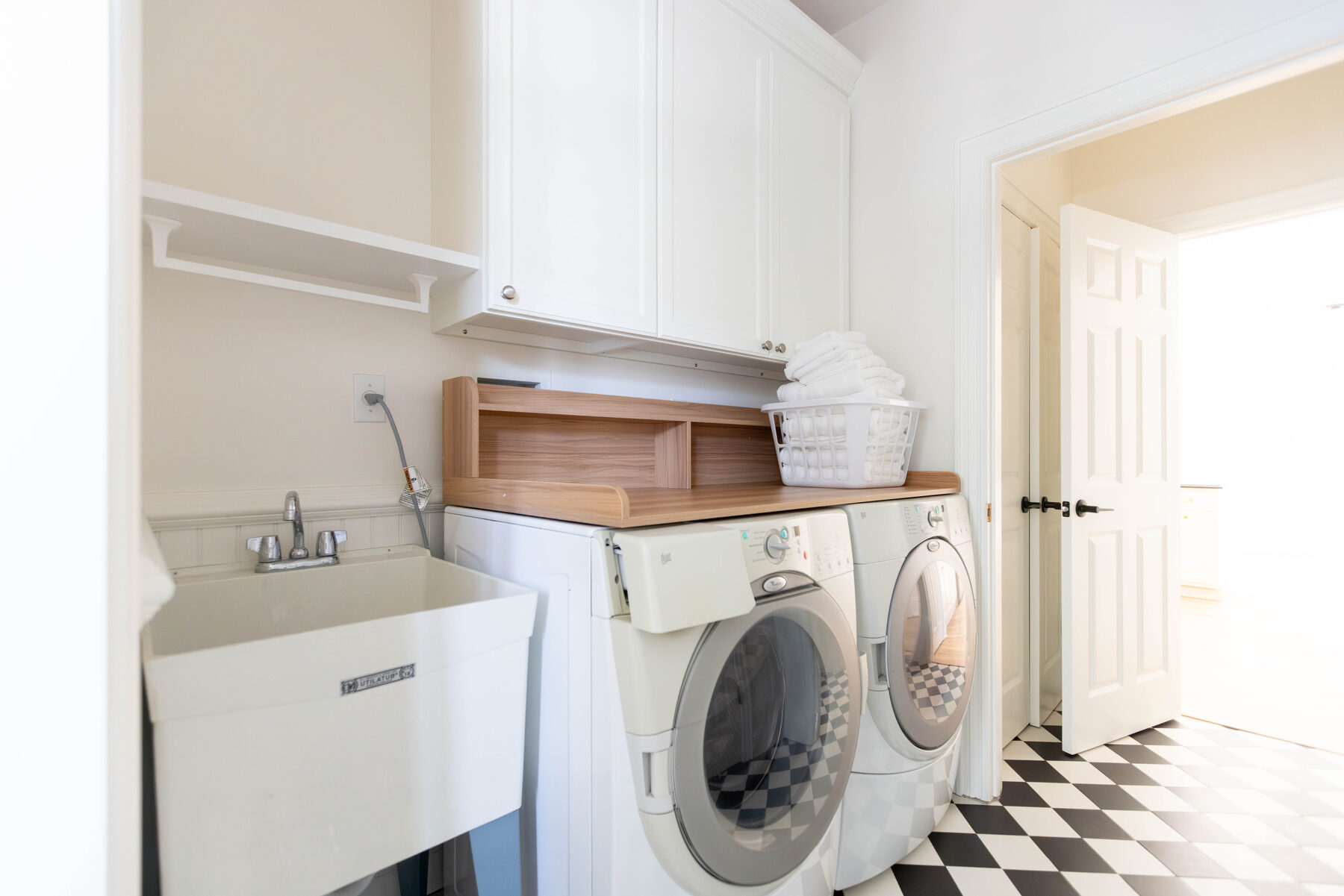 Laundry room with checkerboard tile floor