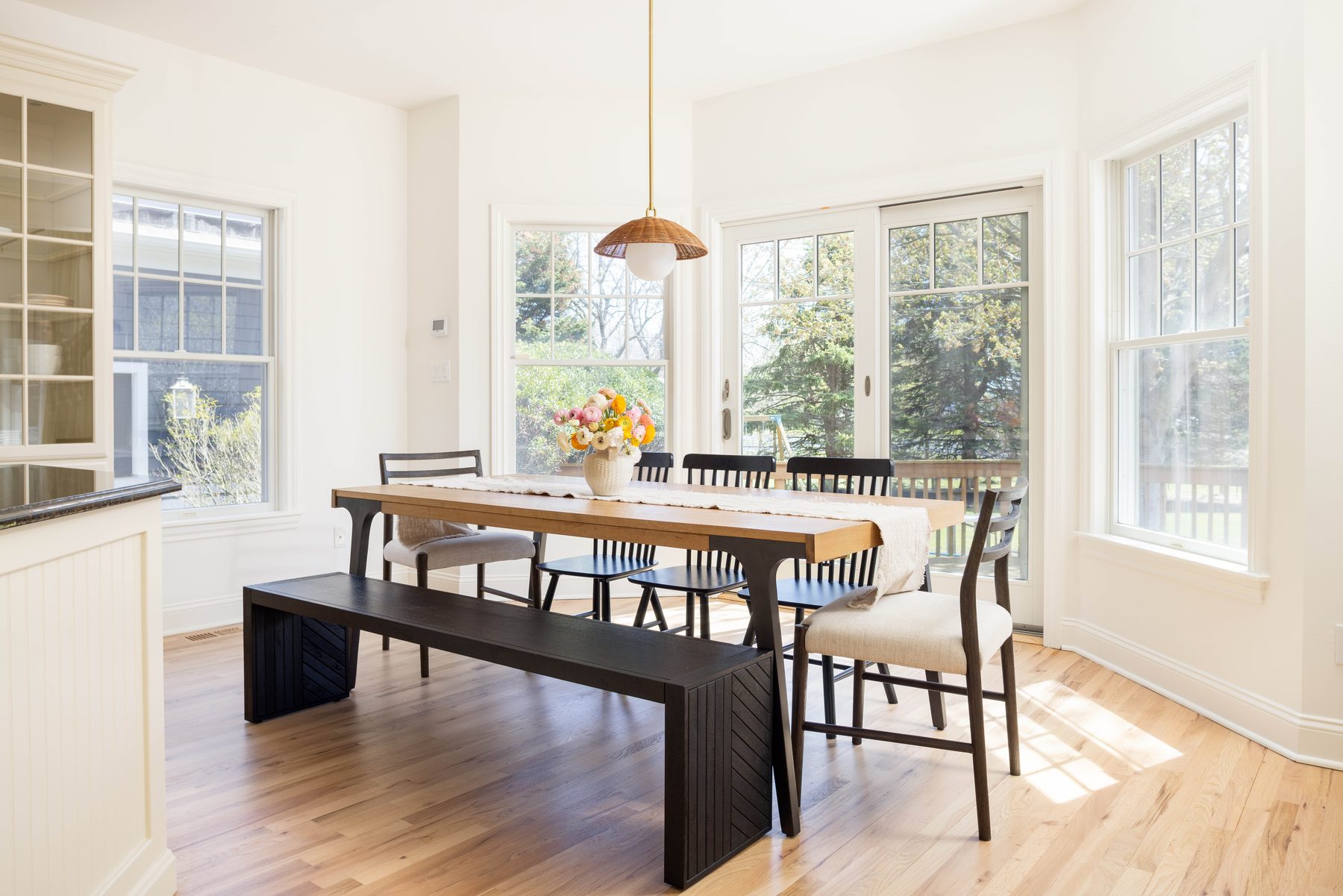 Dining table beneath rattan pendant