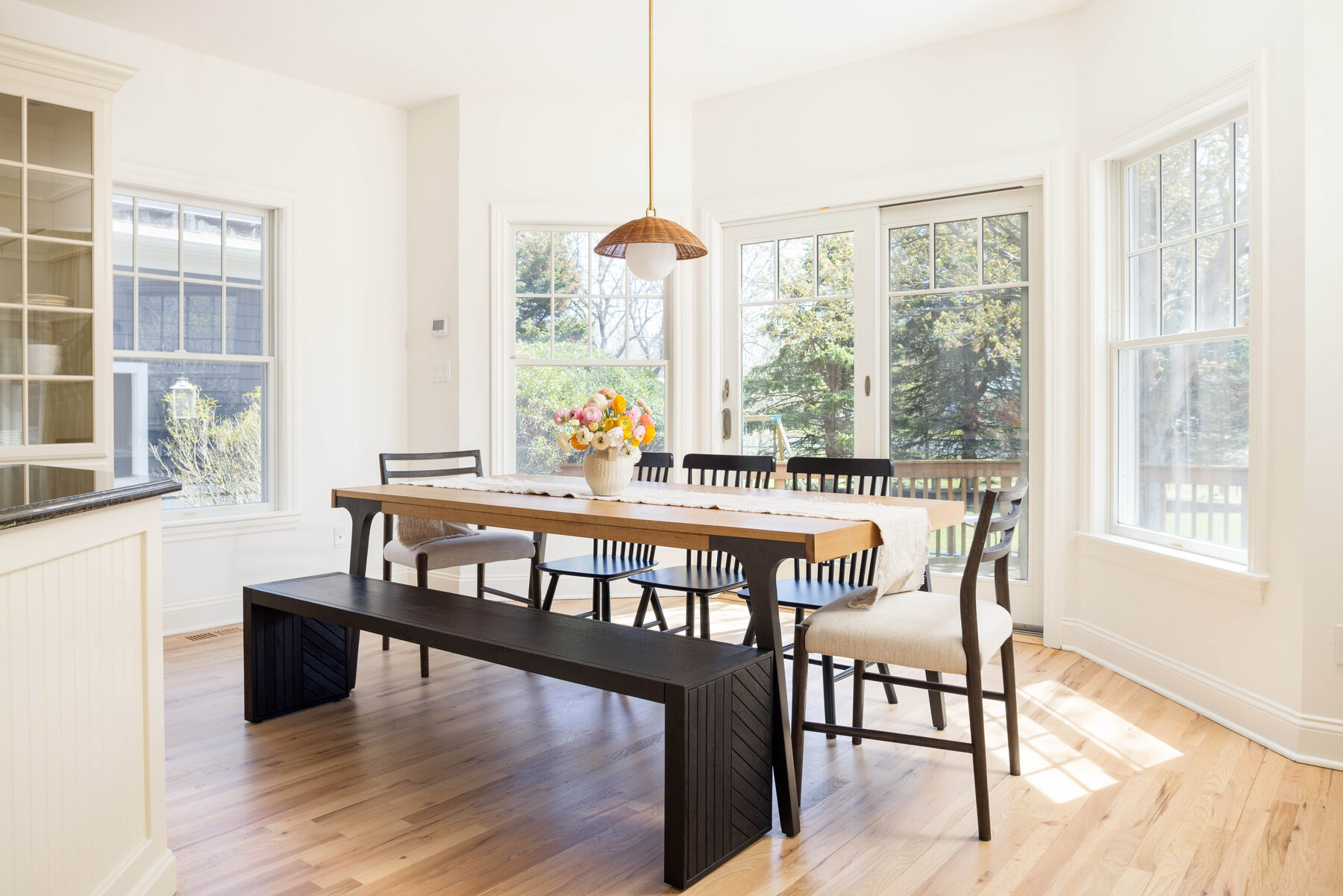 Dining table beneath rattan pendant