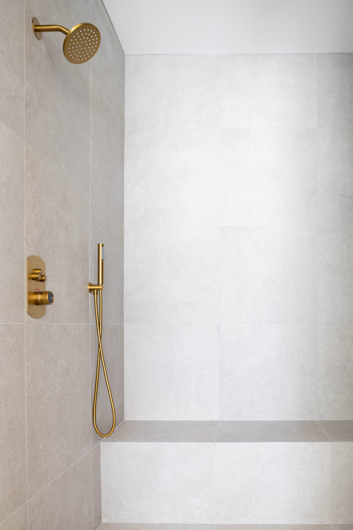 Primary bath — walk-in tile shower with brass fixtures