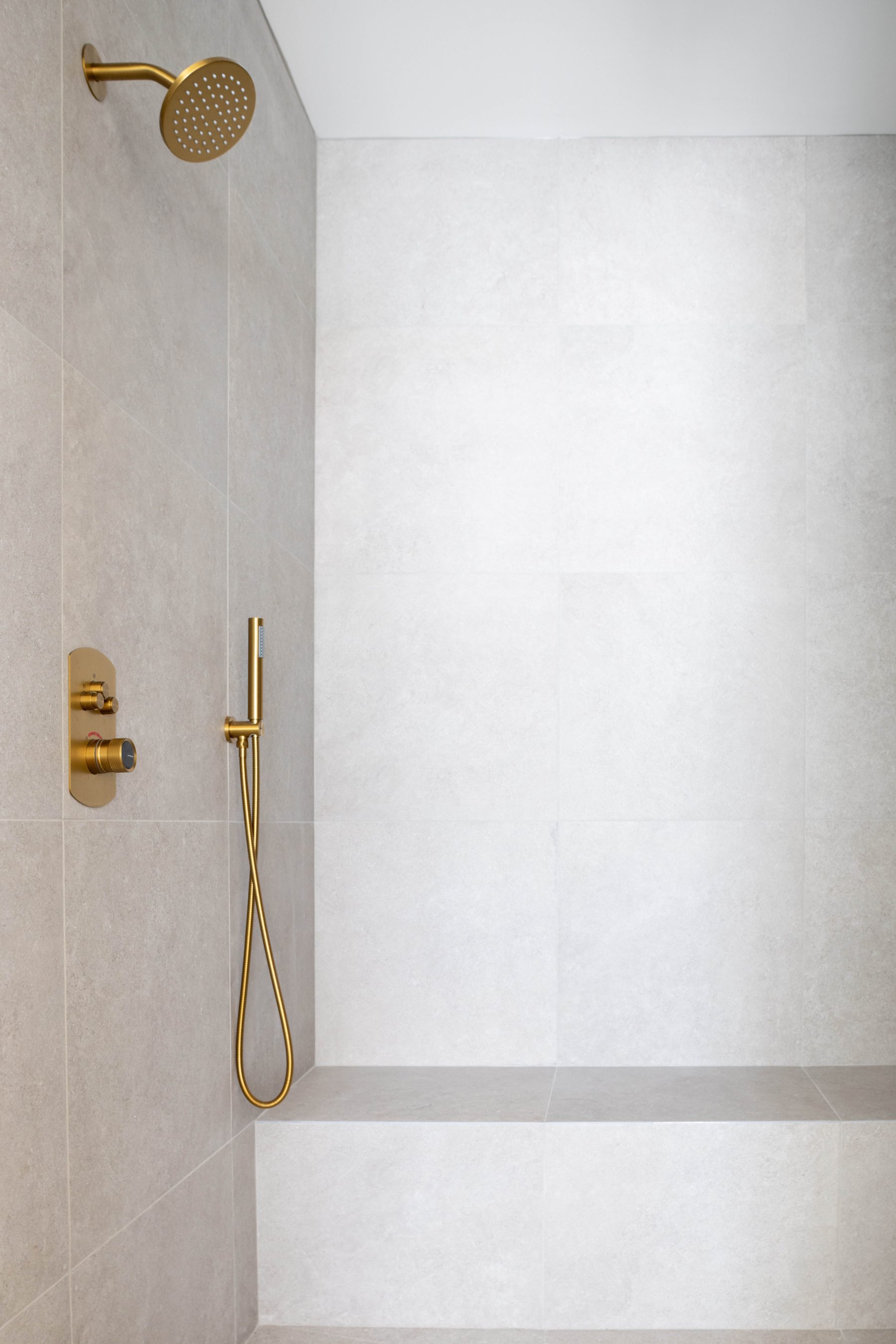 Primary bath — walk-in tile shower with brass fixtures