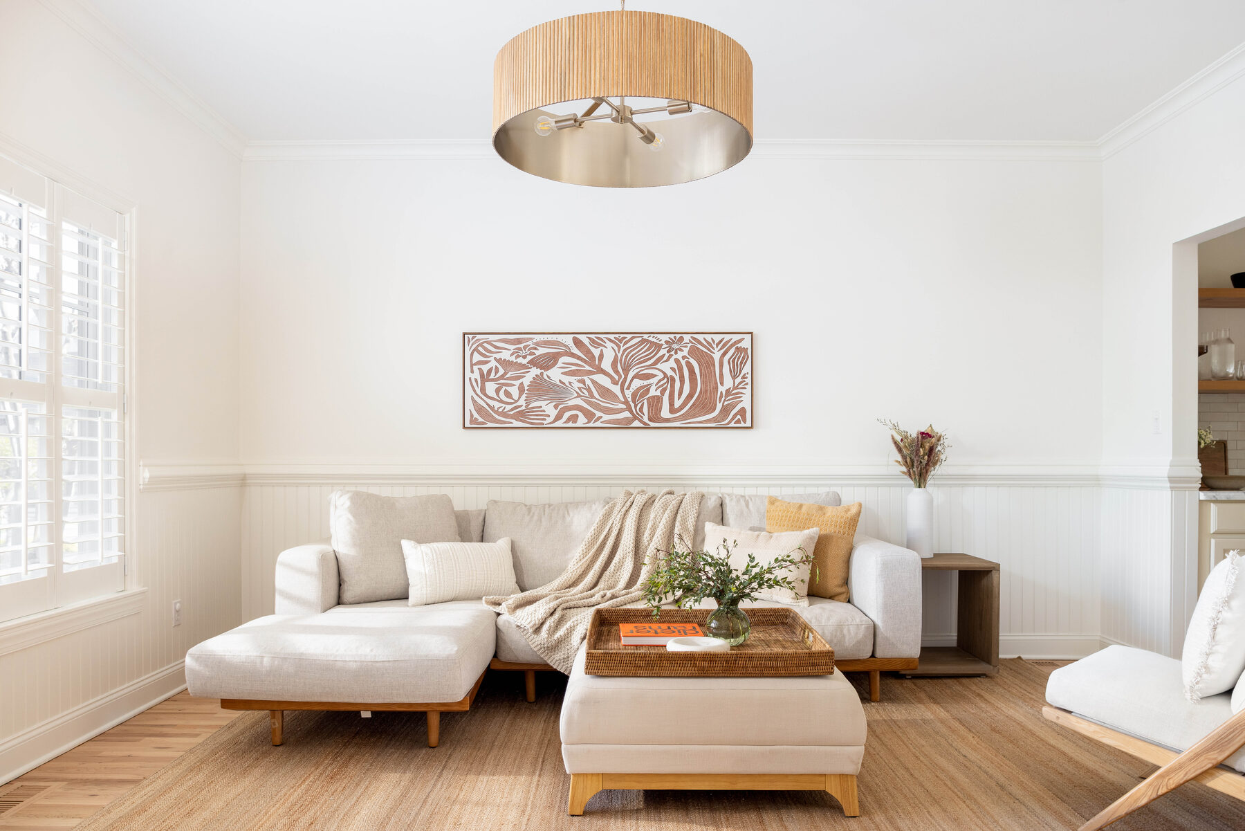 Sun-filled living room with a deep white sectional