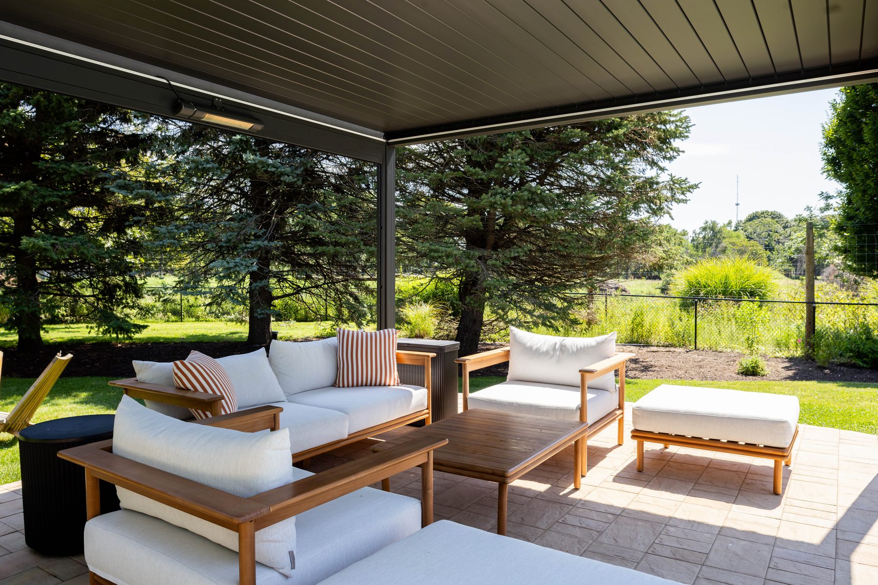 Pergola lounge — outdoor living room beside the lawn