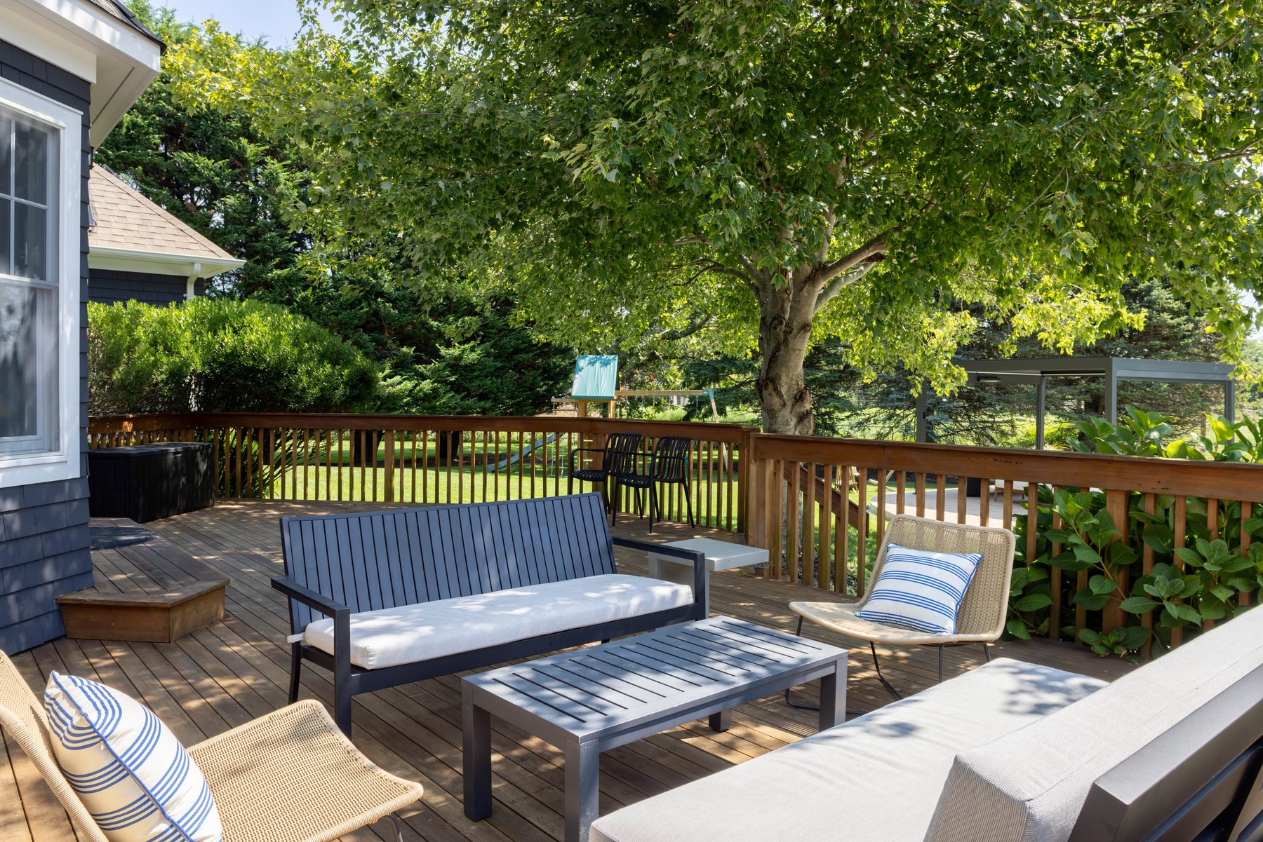 Deck — porch swing and lounge seating in the shade